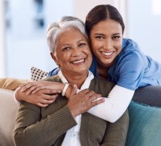 healthcare worker hug an elderly