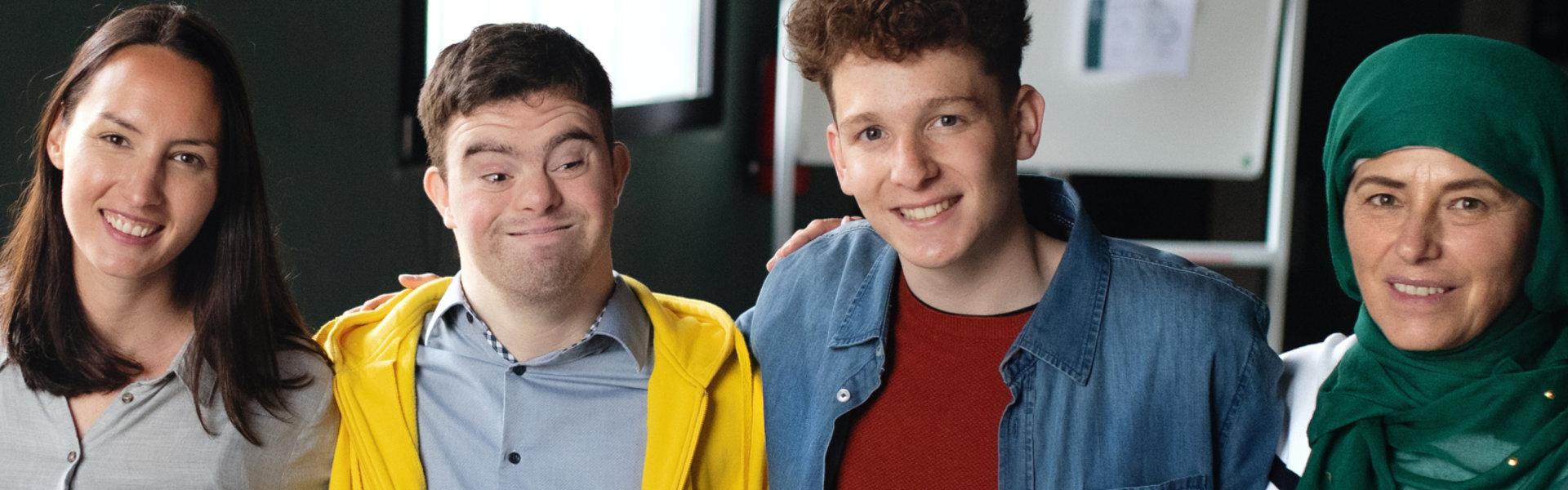 Portrait of four people smiling