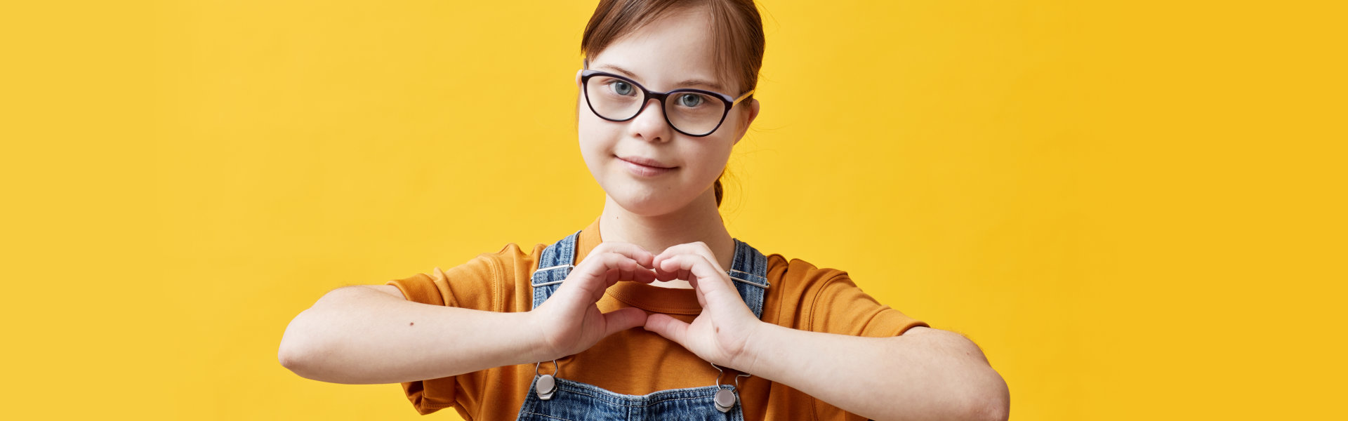 girl showing heart shape